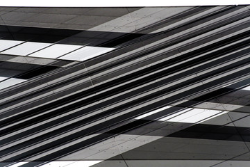 Poster - Low angle view of gray steel wall panels with slots. Fragment of industrial building exterior. Abstract modern architecture background with geometric structure. Parallel lines in diagonal composition.