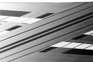 Poster - Low angle view of gray steel wall panels with slots. Fragment of industrial building exterior. Abstract modern architecture background with geometric structure. Parallel lines in diagonal composition.