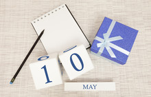 Calendar With Trendy Blue Text And Numbers For May 10 And A Gift In A Box.