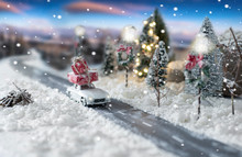Miniature Classic Car Carrying A Christmas Gifts On Snowy Winter Landscape