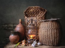 Rural Still Life With Old Baskets And Lighting Lantern