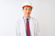 © Krakenimages.com - Chinese architect man wearing coat and helmet standing over isolated white background with a happy and cool smile on face. Lucky person.