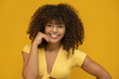 © Nexa - African american woman with afro hairstyle and glamour glam makeup. Yellow background.