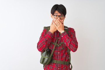 Wall Mural - Chinese hiker man wearing backpack canteen glasses over isolated white background shocked covering mouth with hands for mistake. Secret concept.