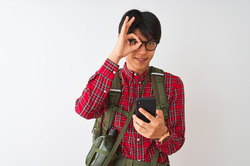 Wall Mural - Chinese hiker man wearing canteen using smartphone over isolated white background with happy face smiling doing ok sign with hand on eye looking through fingers