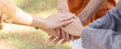 © chinnarach - close up group of people hands merging on top together for cheerful and showing unity at outside for human rights and teamwork concept