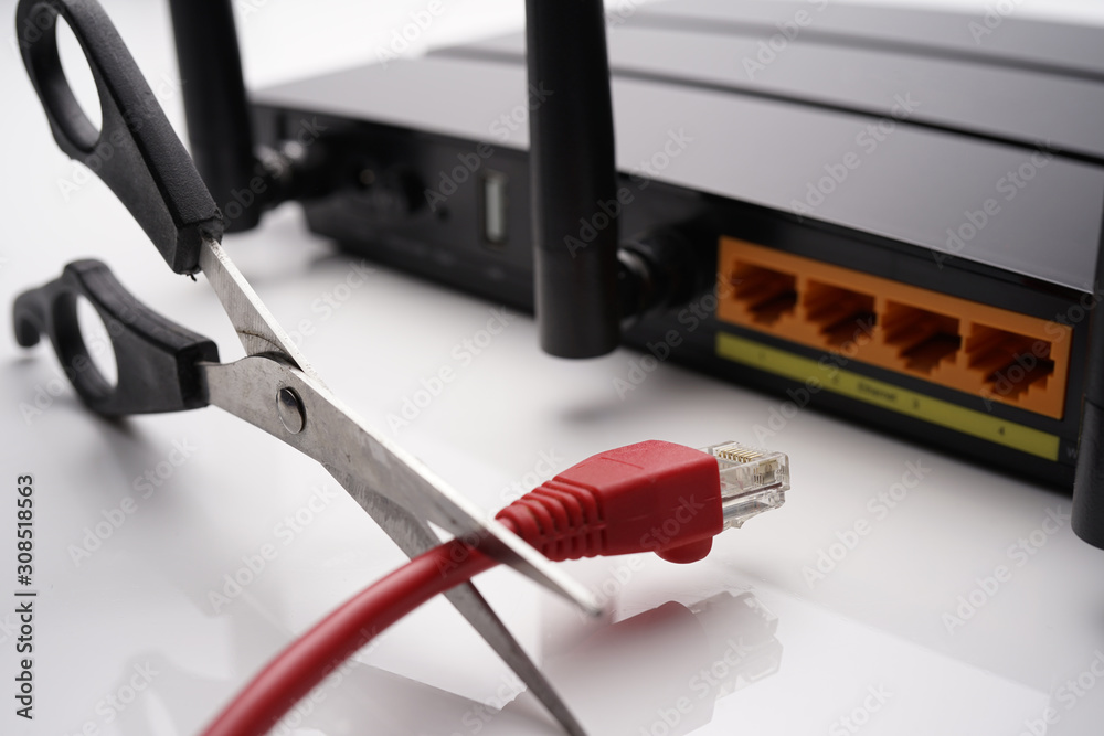 Backside view of dual band wifi router with cat-6 cable and scissors ...