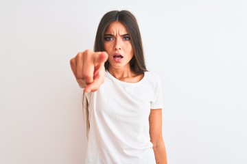 Young beautiful woman wearing casual t-shirt standing over isolated white background pointing displeased and frustrated to the camera, angry and furious with you