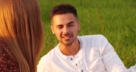 Poster - Happy young couple in park at sunset. Picnic time