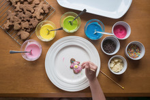 Young Girl Decorating Gingerbread With Frosting