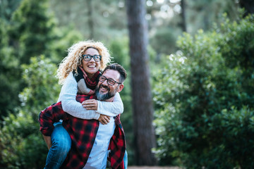 Wall Mural - happy and cheerful caucasian people couple having fun together in friendship and relationship - midd