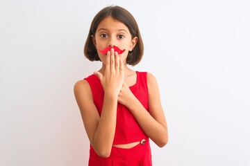 Poster - Beautiful child girl holding fanny party mustache standing over isolated white background cover mouth with hand shocked with shame for mistake, expression of fear, scared in silence, secret concept