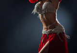 Beautiful belly dance of a girl in a red decorated ethnic dress in dark