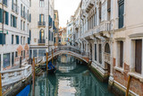 Fototapeta Przestrzenne - Boats on narrow canal between colorful historic houses in Venice.