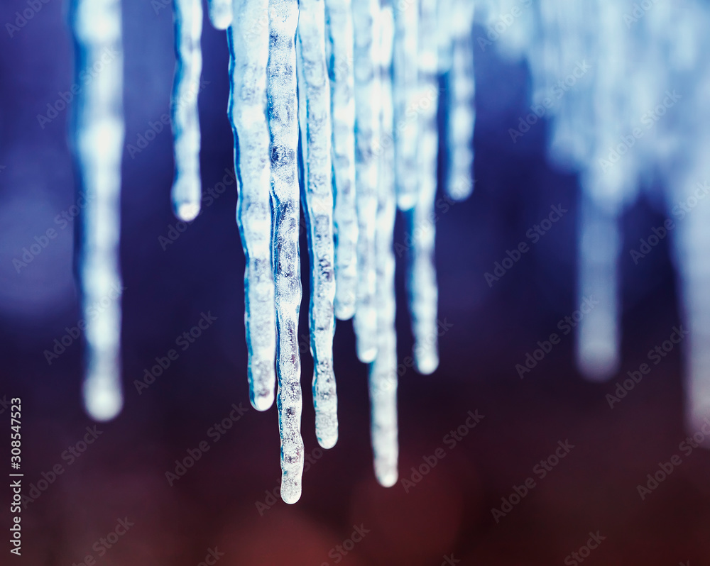 beautiful natural background with shiny transparent icicles hanging in spring Sunny day - obrazy, fototapety, plakaty 