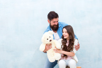 Giving soft toy teddy bear. Lovely father and kid. Father and daughter light background. Strengthening father daughter relationships. Child and dad best friends. Family relations. Fathers day concept