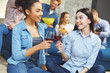 © Viktoriia - Group of friends having party indoors fun together two girls drinking wine