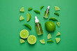 canvas print picture - Flat lay composition with lime essential oil on green background