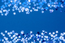 Blue Abstract Christmas Background Border, Frame Texture With Stars Confetti On Blue Background. Space For Text.