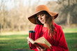 © o_lypa - Young woman on bench with thermos and book.