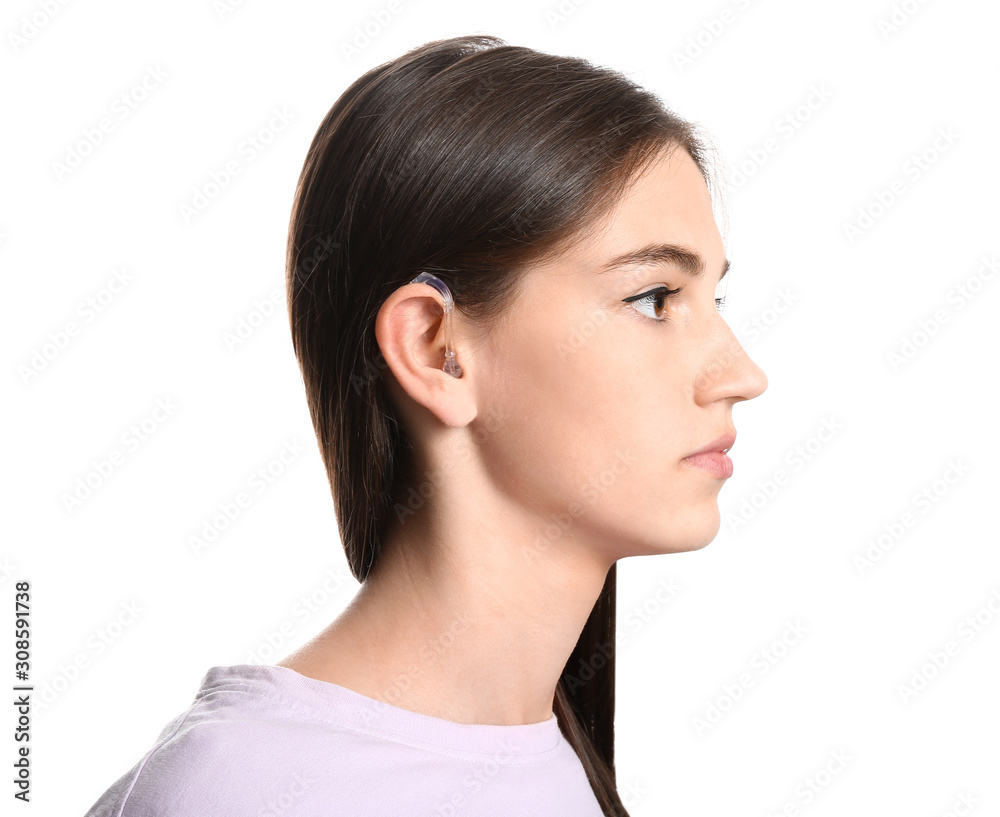 Young woman with hearing aid on white background