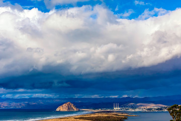 Wall Mural - Cloud over Ocean and City, town Rock 