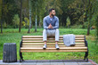 © snb2087 - Young sexy guy sitting on a bench in an autumnal, summer park. A man contemplating new ideas while walking. European countryside. Stock Photo