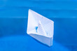 © Duha - checkered paper boat in blue water