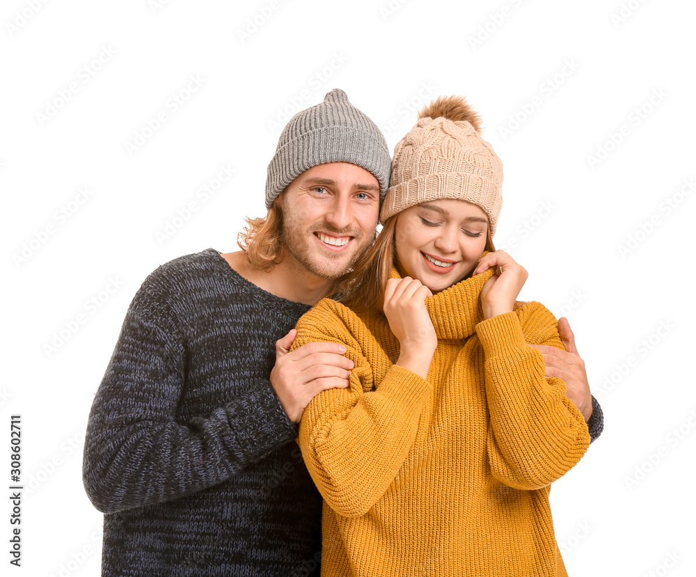 Happy couple in winter clothes on white background