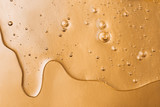 Hyaluronic acid gel. Textured background with oxygen bubbles on silver background.