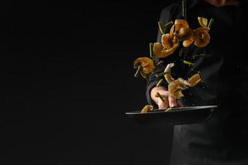 Wall Mural - Asian cuisine. Seafood, cooking shrimp with vegetables, freezing in motion. On a dark background, horizontal photo, healthy and wholesome food