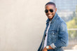 © elnariz - Cool hip stylish african american man in sun glasses and a jean jacket, lifestyle portrait on rooftop