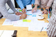 © jat306 - Graphic designers work together with UX UI designer planning application template layout framework for mobile phone computer mobile