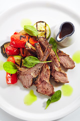 Sticker - Grilled Lamb Rack with Baked Vegetables on White Restaurant Plate Top View