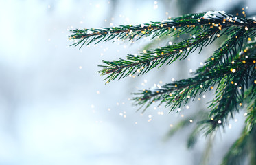 Christmas tree outdoor with snow, lights bokeh around, and snow falling, Christmas atmosphere.