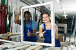 © JackF - Portrait of man and woman worker who are standing with window frames