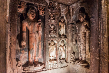 AJANTA, INDIA - FEBRUARY 6, 2017: Buddha images in a  monastery (vihara) carved into a cliff in Ajanta, Maharasthra state, India