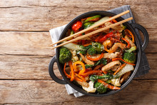Chinese Cuisine Stir Fry Pork With Vegetables And Sesame Seeds Close-up In A Pan. Horizontal Top View