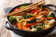Healthy stir fried pork with different vegetables close-up in a pan. horizontal