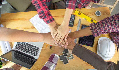 Engineer or architect people coordinate hands in office. Concept Teamwork.