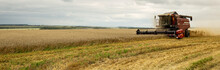 Combine Harvester Working On A Wheat Field. Seasonal Harvesting The Wheat. Agriculture. Panoramic Banner. 