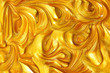 canvas print picture - Close up liquid luxury gold metallic glitter paint swirls to make an abstract textured background