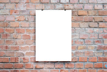 Poster Design Presentation Mockup. Blank Paper Poster Hanging Attached With Clips Across Brick Wall
