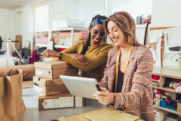 Wall Mural - Sales Online. Working women at their store. They accepting new orders online and packing merchandise for customer.