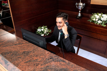 Wall Mural - Hard working receptionist talking over phone