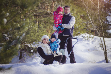  Happy family at winter snowy forest