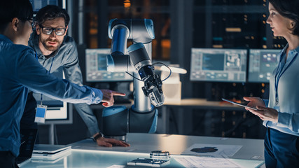 Poster - Diverse Team of Engineers with Laptop and a Tablet Analyse and Discuss How a Futuristic Robotic Arm Works and Moves a Metal Object. They are in a High Tech Research Laboratory with Modern Equipment.