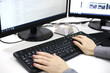 © Oksana - Female hands typing on computer keyboard opposite the monitor. Accounting and Auditing concept