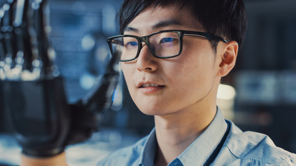 Poster - Close Up of a Futuristic Prosthetic Robot Arm Being Tested by a Professional Japanese Development Engineer in a High Tech Research Laboratory with Modern Computer Equipment.