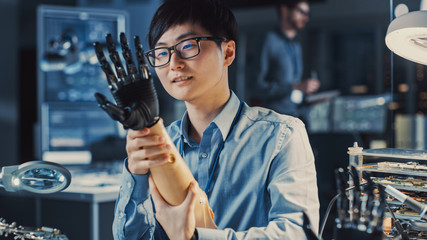 Poster - Futuristic Prosthetic Robot Arm Being Tested by a Professional Japanese Development Engineer in a High Tech Research Laboratory with Modern Computer Equipment. He is Satidfied with the Result.
